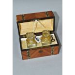 A 19TH CENTURY CASKET SHAPED PERFUME BOX, containing two glass scent bottles with floral gilt