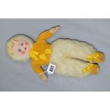 A CLOTH FACED DOLL, painted features, yellow velvet top and shoes, white furry hat and trousers,
