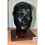 A LATE 20TH CENTURY BLACK GLAZED PLASTER BUST OF AN AFRICAN WOMAN, mounted on a square wooden