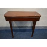 A GEORGIAN MAHOGANY FOLD OVER TEA TABLE with rounded and reeded edges on square tapering legs