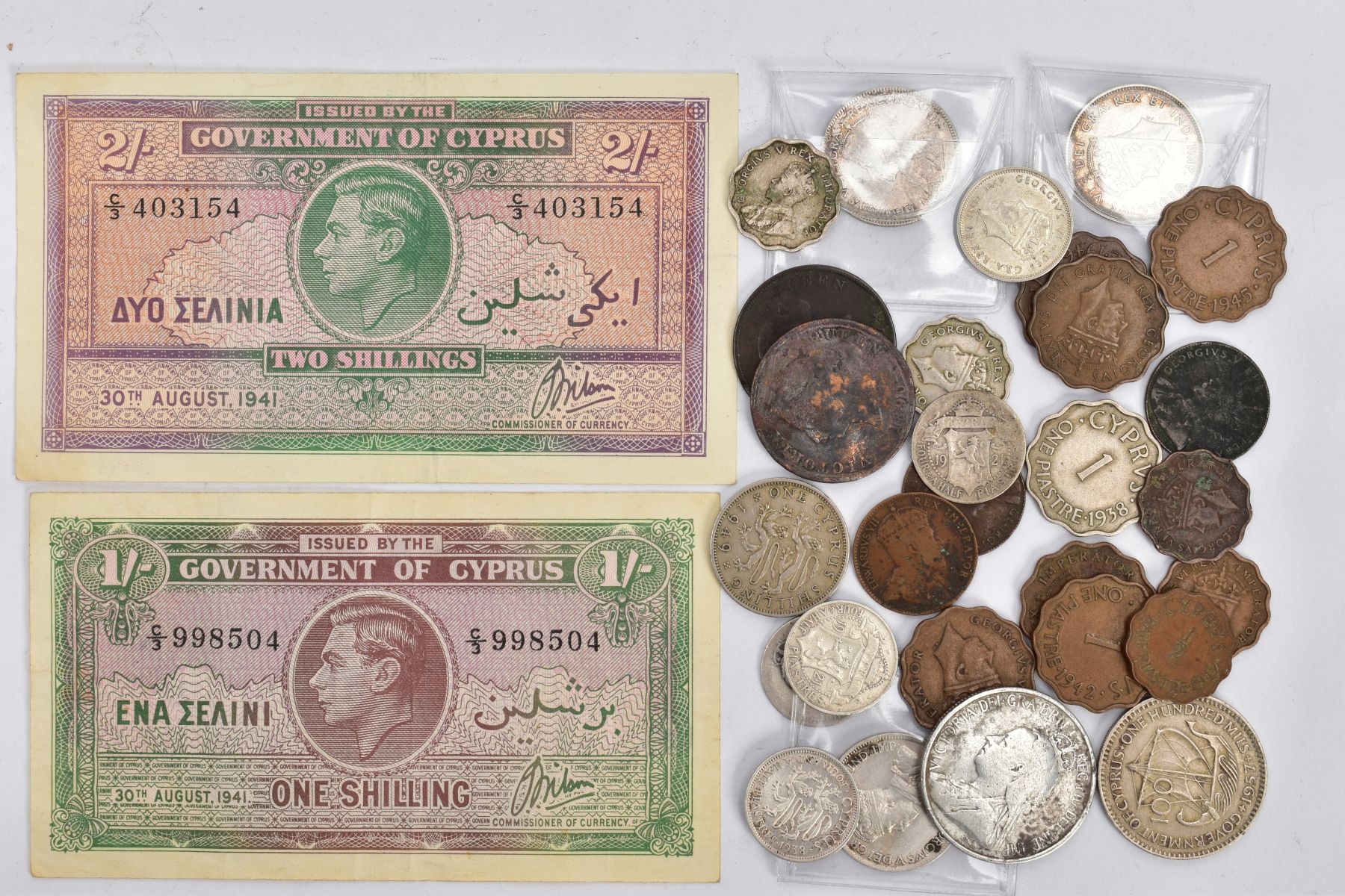 A quantity of world coins to include: a package of Cypriot coins 3x Nine piastre coins 1919,1921,