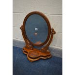 A VICTORIAN MAHOGANY OVAL DRESSING MIRROR