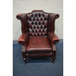 A LEATHER OXBLOOD CHESTERFIELD WINGBACK ARM CHAIR (condition - pet scratches to top)