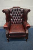 A LEATHER OXBLOOD CHESTERFIELD WINGBACK ARM CHAIR (condition - pet scratches to top)