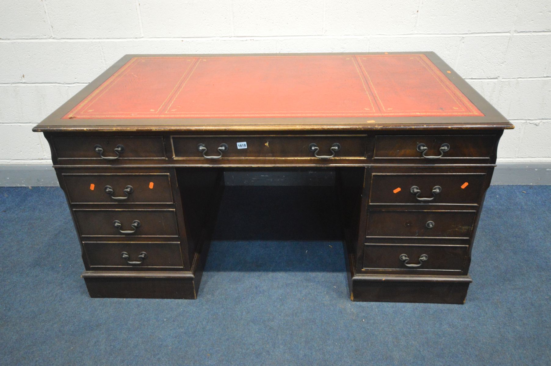 A LARGE REPRODUCTION MAHOGANY PEDESTAL DESK, with a red leather and gilt tooled inlay top, and eight