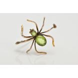 A YELLOW METAL SPIDER BROOCH, set with an oval and a circular cut peridot to the body and head, each