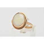 A YELLOW METAL OPAL RING, designed with an oval cut opal cabochon measuring approximately 13.9mm x