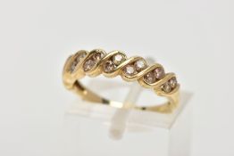 A 9CT GOLD DIAMOND HALF ETERNITY RING, set with two asymmetrical rows of round brilliant cut, tinted
