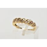 A 9CT GOLD DIAMOND HALF ETERNITY RING, set with two asymmetrical rows of round brilliant cut, tinted