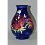 A MOORCROFT POTTERY BALUSTER VASE, decorated with anemone pattern on a dark blue ground, silver