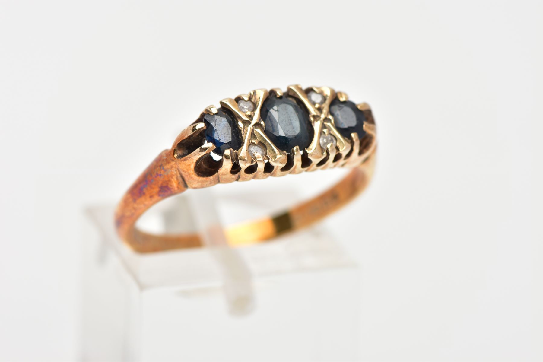 A 9CT GOLD SAPPHIRE AND DIAMOND RING, designed with three graduated oval cut blue sapphires, - Image 4 of 4