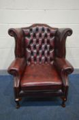 A LEATHER OXBLOOD CHESTERFIELD WINGBACK ARM CHAIR