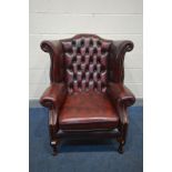 A LEATHER OXBLOOD CHESTERFIELD WINGBACK ARM CHAIR