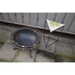 A FIRE PIT with a cylindrical metal frame on shaped legs with bowl insert along with an outdoor