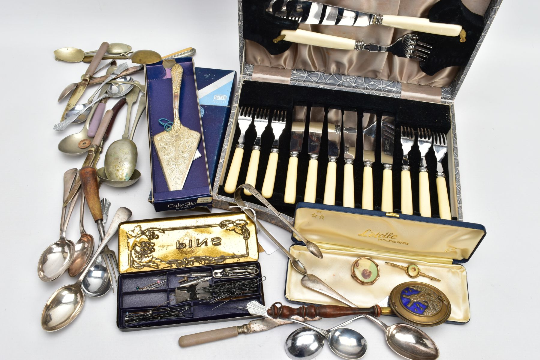 A BOX OF ASSORTED CUTLERY AND ITEMS, to include a pair of George III, bright cut sugar tongs,