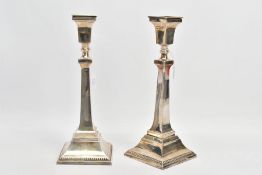 A PAIR OF SILVER CANDLESTICKS, each candlestick of a square design, tapered square stems and
