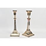 A PAIR OF SILVER CANDLESTICKS, each candlestick of a square design, tapered square stems and