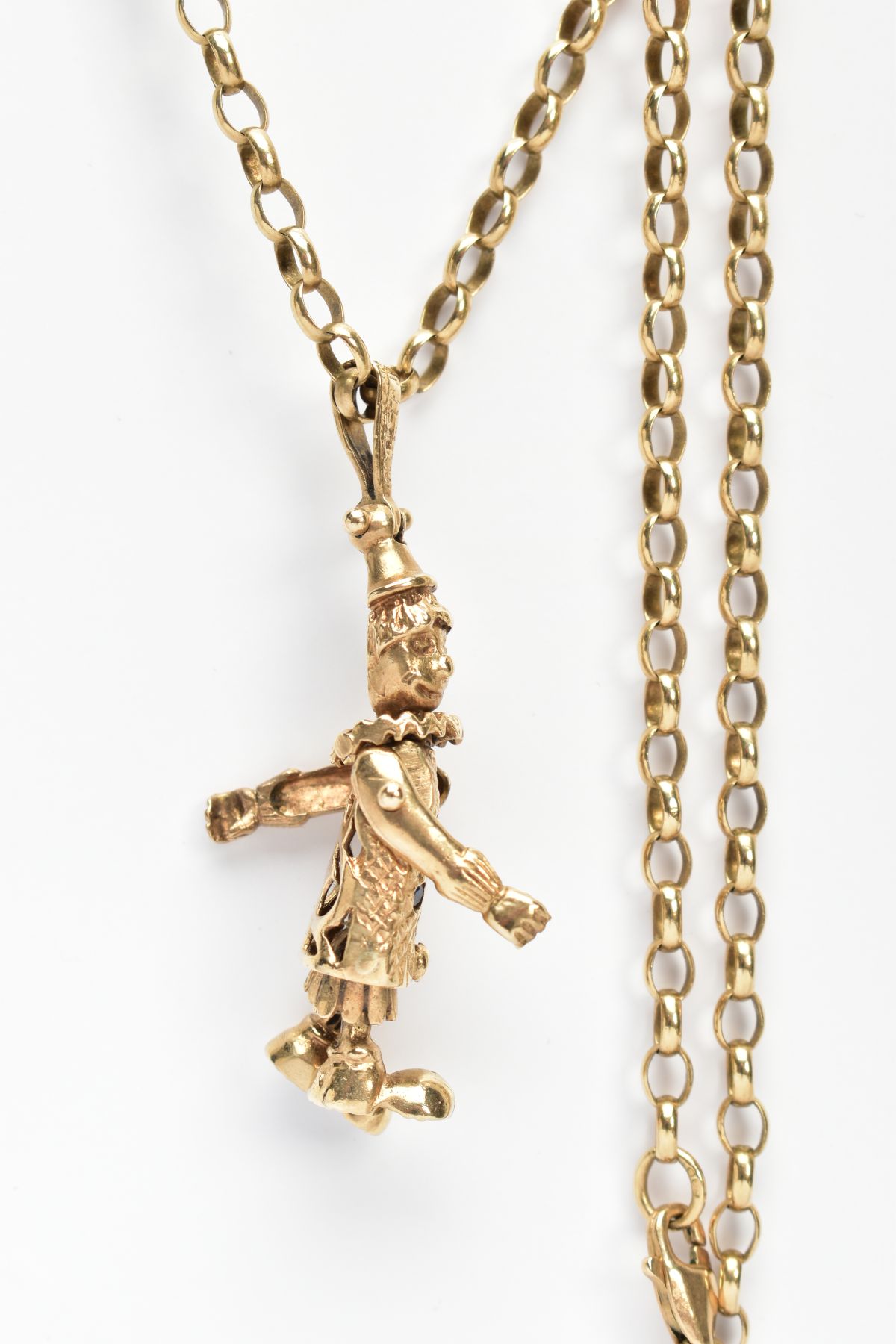 A 9CT GOLD CLOWN PENDANT AND CHAIN, the articulated clown set with four stones to the body, fitted - Image 3 of 4