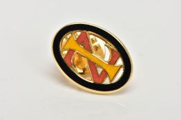 A YELLOW METAL ENAMELLED MONOGRAM PIN, of an oval openwork form, decorated with black, yellow and