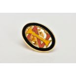 A YELLOW METAL ENAMELLED MONOGRAM PIN, of an oval openwork form, decorated with black, yellow and