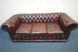 A LEATHER OXBLOOD CHESTERFIELD THREE SEATER SOFA, length 189cm x depth 83cm x height 70cm