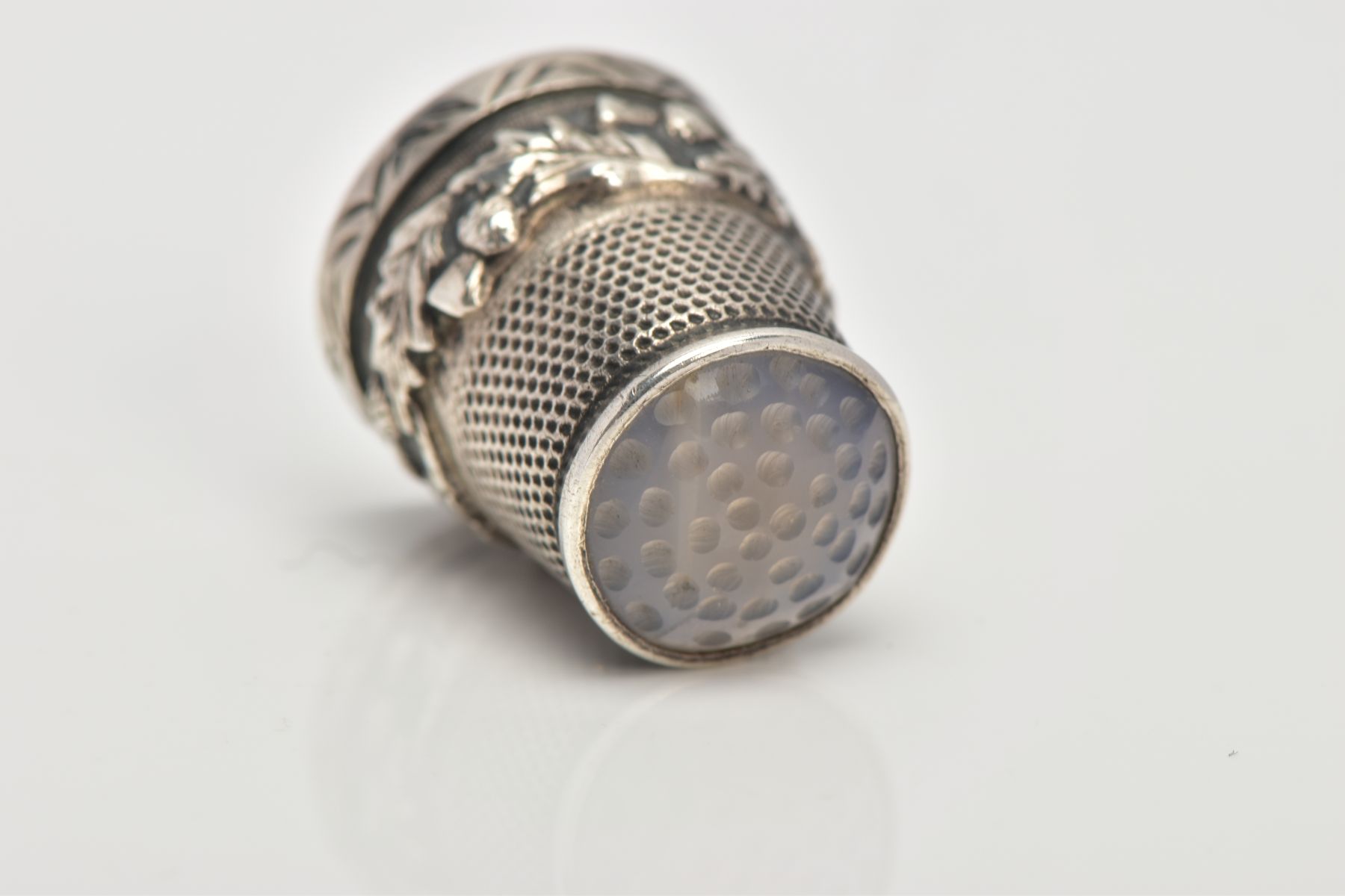 A SILVER THIMBLE, decorated with thistles and set with a possibly chalcedony terminal, hallmarked ' - Image 2 of 4