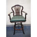 A TALL MAHOGANY EFFECT HIGH STOOL with open armrests and green leatherette seat, width 64cm x