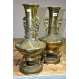 A PAIR OF CHINESE BRONZE VASES, dragon handles to the necks, the vases are raised on three