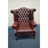 A LEATHER OXBLOOD CHESTERFIELD WINGBACK ARM CHAIR