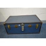 A VINTAGE BLUE TRAVELLING TRUNK (condition - rips to top and bottom) (key)