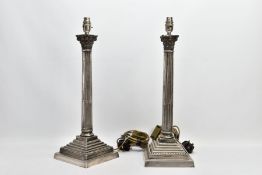 A PAIR OF ELECTROPLATED CORINTHIAN COLUMN LAMPS, each on a square stepped base with beaded detail,