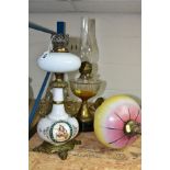 THREE LAMPS comprising an opaque white oil lamp with transfer and hand painted decoration, brass