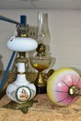 THREE LAMPS comprising an opaque white oil lamp with transfer and hand painted decoration, brass