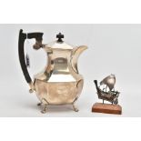 A GEORGE VI SILVER HOT WATER JUG AND A WHITE METAL SHIP ORNAMENT, the water jug of a faceted form,
