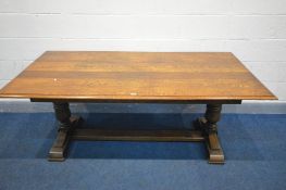 A REPRODUCTION SOLID OAK REFRECTORY TABLE, on a trestle base, length 184cm x width 92cm x height