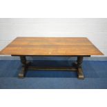 A REPRODUCTION SOLID OAK REFRECTORY TABLE, on a trestle base, length 184cm x width 92cm x height