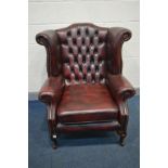 A LEATHER OXBLOOD CHESTERFIELD WINGBACK ARM CHAIR