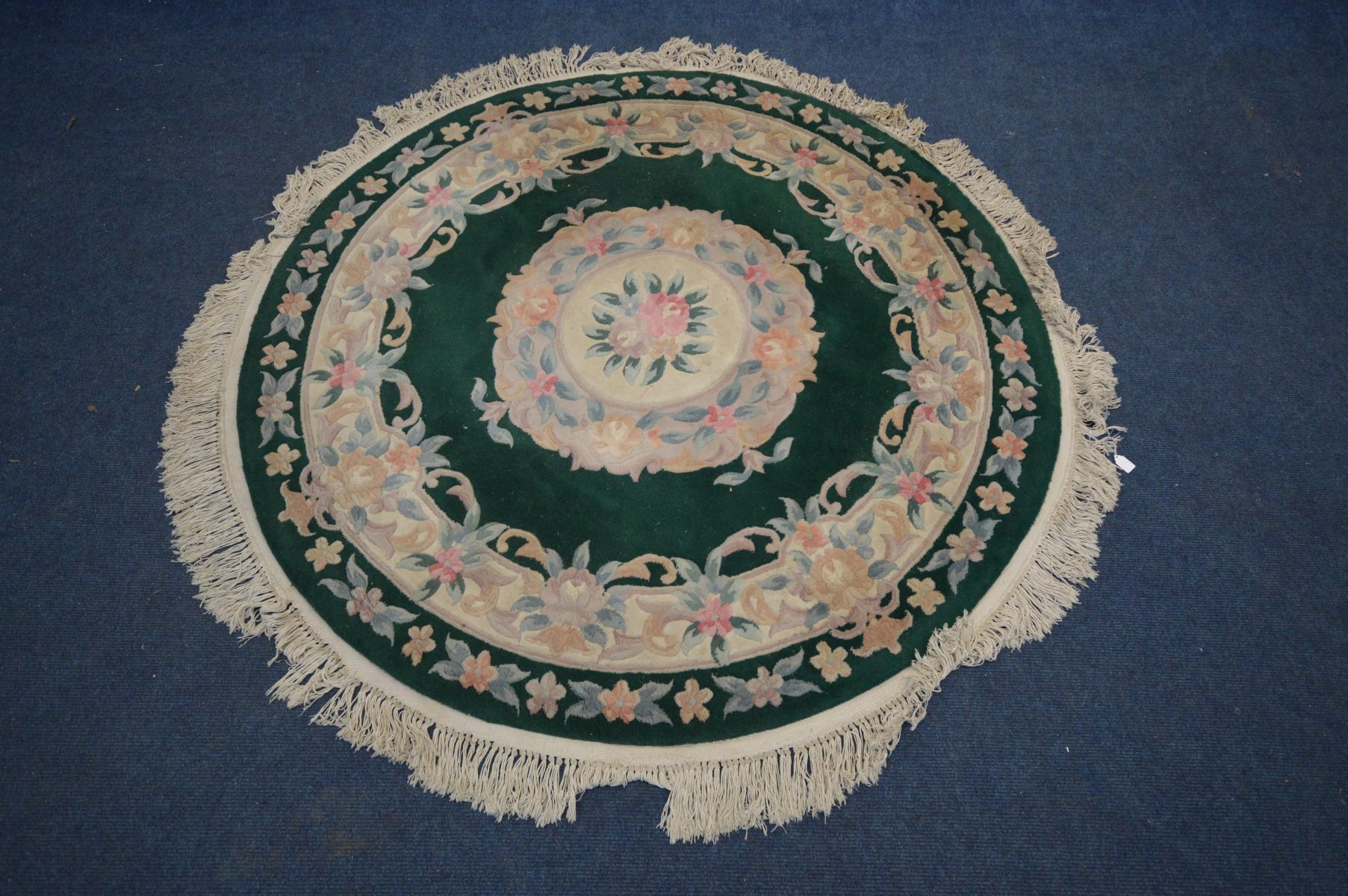 A CIRCULAR GREEN CHINESE RUG, diameter 162cm