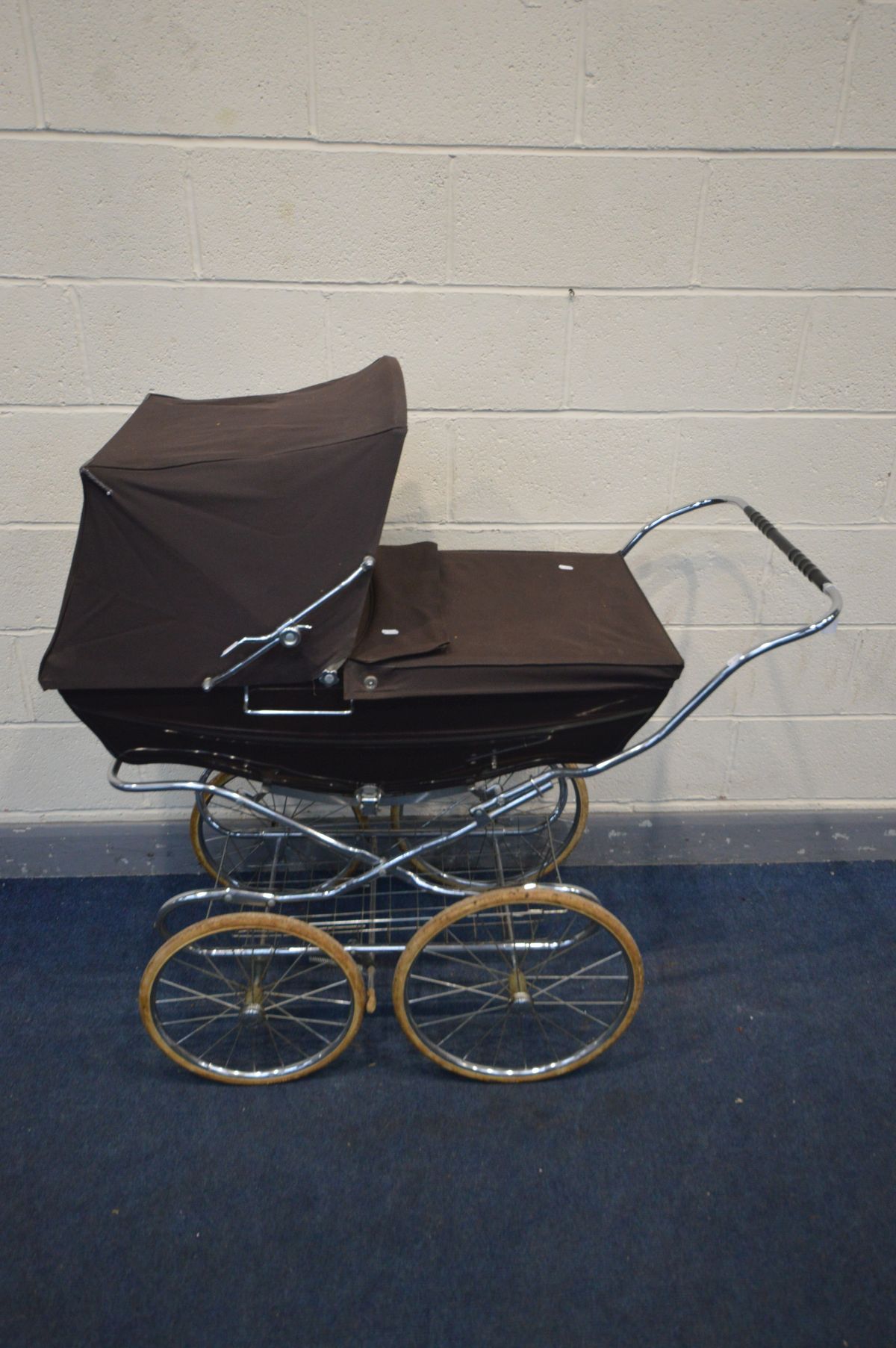 A FOLDING SILVER CROSS PRAM