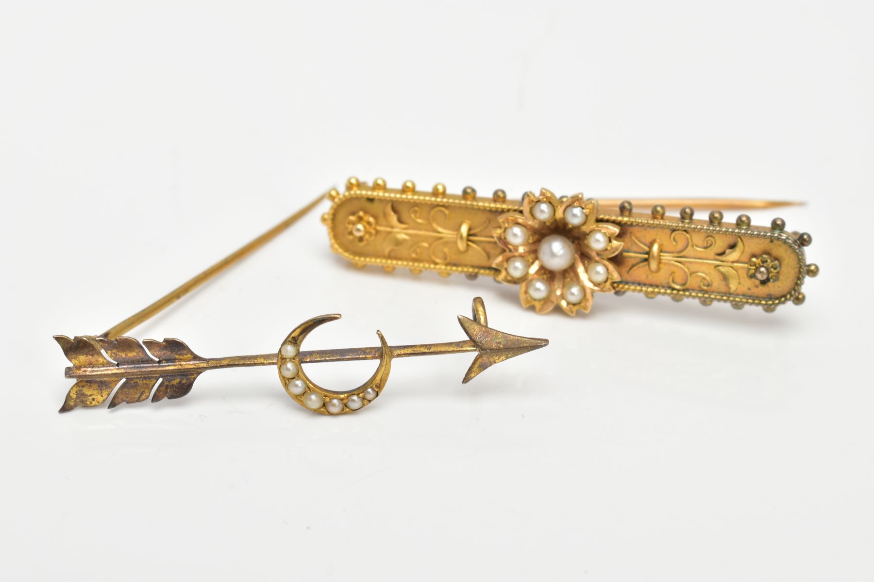 TWO YELLOW METAL SEED PEARL BROOCHES, the first a bar brooch, set with a seed pearl flower, on a