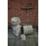 A VINTAGE METAL FRAMED COMPOSITE GARDEN ROLLER, a composite urn with fleur de lis detailing on a