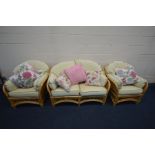 A FOUR PIECE WICKER CONSERVATORY SUITE, comprising of a two seater sofa, two arm chairs and a coffee