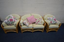 A FOUR PIECE WICKER CONSERVATORY SUITE, comprising of a two seater sofa, two arm chairs and a coffee