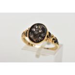 A MID VICTORIAN DIAMOND AND BLACK ENAMEL MEMORIAL RING, the oval ring head with a flower design