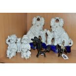 A PAIR OF LATE VICTORIAN STAFFORDSHIRE POTTERY SEATED SPANIEL AND PUPPIES ON HIND LEGS FIGURES, on