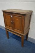 AN OAK DOUBLE DOOR CUPBOARD with fielded panels, on square tapering legs, width 65cm x depth 37cm