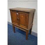 AN OAK DOUBLE DOOR CUPBOARD with fielded panels, on square tapering legs, width 65cm x depth 37cm