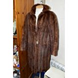 A LADIES CONEY FUR COAT, with hook fastenings at waist and collar, approximate size 12-14,