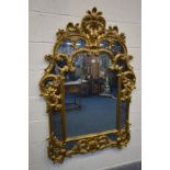 A REPRODUCTION ITALIAN GILT FRAMED WALL MIRROR, 98cm x 140cm