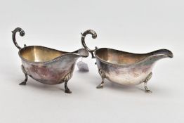 TWO SILVER GRAVY BOATS, each of a plain polished design, gadrooned rim, scroll detailed handle,